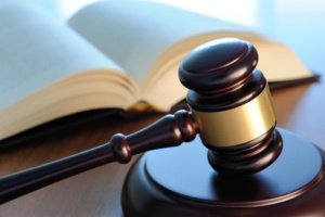 Gavel with book on a wood surface