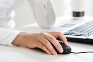 Image of female hand touching computer mouse