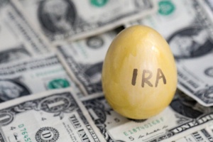 IRA retirement saving golden egg on cash
